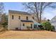 View of the backyard with a patio set, a grill and an expansive lawn at 302 Roswell Green Ln, Roswell, GA 30075