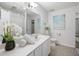 Bright bathroom featuring a large mirror, white vanity, and neutral decor at 302 Roswell Green Ln, Roswell, GA 30075