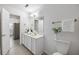 Bright bathroom featuring white cabinets and views into the hallway and kitchen at 302 Roswell Green Ln, Roswell, GA 30075