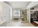 Bright bathroom with a glass enclosed shower, a cozy bench, and a linen closet provides ample storage at 302 Roswell Green Ln, Roswell, GA 30075