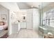 Beautiful bathroom featuring double sinks, tiled floors, and a glass-enclosed shower at 302 Roswell Green Ln, Roswell, GA 30075