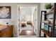 View from office through double doors to the bedroom featuring hardwood floors and a cozy bed at 302 Roswell Green Ln, Roswell, GA 30075