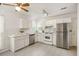 Well-lit kitchen features stainless appliances, white cabinets, and tile backsplash at 302 Roswell Green Ln, Roswell, GA 30075