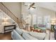 Welcoming living room is bathed in natural light and features hardwood floors and a classic staircase at 302 Roswell Green Ln, Roswell, GA 30075