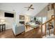 Spacious living room featuring vaulted ceilings, hardwood floors, and an attractive brick fireplace at 302 Roswell Green Ln, Roswell, GA 30075