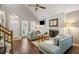 Inviting living room showcasing hardwood floors, a brick fireplace, and a vaulted ceiling for an open feel at 302 Roswell Green Ln, Roswell, GA 30075