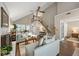 Bright living room boasts a vaulted ceiling, wood floors, a brick fireplace, and a staircase to the second level at 302 Roswell Green Ln, Roswell, GA 30075