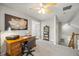 Comfortable home office featuring a spacious desk, soft carpeting, a ceiling fan and ample space for work at 302 Roswell Green Ln, Roswell, GA 30075