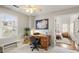 Home office featuring a ceiling fan, a desk, a large window, and neutral colored carpet at 302 Roswell Green Ln, Roswell, GA 30075