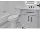 Bathroom with a sleek vanity, toilet, and a bathtub with white tile at 5075 S Woodbridge Trl, Stone Mountain, GA 30088