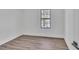 Bedroom featuring wood look flooring, a window, and fresh white paint at 5075 S Woodbridge Trl, Stone Mountain, GA 30088