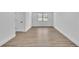Wood-look floors, white baseboards and walls, and a single window makes this a cozy room at 5075 S Woodbridge Trl, Stone Mountain, GA 30088