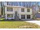 Lovely exterior view of a two-story home with a cozy front porch and an attached garage at 5075 S Woodbridge Trl, Stone Mountain, GA 30088