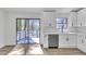 Modern kitchen with white cabinets, stainless steel appliances, and a view to the deck at 5075 S Woodbridge Trl, Stone Mountain, GA 30088