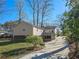 Rear view of the home showing the backyard, deck, and driveway on a sunny day at 527 Scott Cir, Decatur, GA 30033