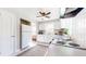 Functional kitchen area with white appliances and cabinets, tile backsplash, and a ceiling fan at 527 Scott Cir, Decatur, GA 30033