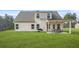 Expansive backyard with a covered patio, perfect for outdoor dining and entertaining, with lush green lawn at 6441 Oakhurst Pl, Fairburn, GA 30213