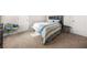 Cozy bedroom featuring a queen-sized bed with stylish striped bedding and neutral walls at 6441 Oakhurst Pl, Fairburn, GA 30213