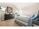 Spacious bedroom featuring neutral-toned carpet, natural lighting, and a dark wood dresser at 6441 Oakhurst Pl, Fairburn, GA 30213