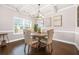 Bright dining room with hardwood floors, a modern chandelier, and a stylish table for formal dining experiences at 6441 Oakhurst Pl, Fairburn, GA 30213