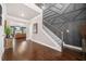 Elegant foyer with hardwood flooring, decorative wall trim, staircase, and an inviting view to the living space at 6441 Oakhurst Pl, Fairburn, GA 30213