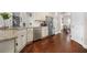 Modern kitchen with stainless steel appliances, granite countertops, and hardwood flooring at 6441 Oakhurst Pl, Fairburn, GA 30213