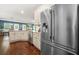 Well-equipped kitchen with stainless steel appliances, granite countertops, and a view into the adjacent living space at 6441 Oakhurst Pl, Fairburn, GA 30213