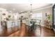 Bright kitchen features an island with barstool seating, a hanging light, and stainless steel appliances at 6441 Oakhurst Pl, Fairburn, GA 30213