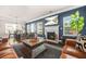 Warm living room boasting a fireplace, large TV, and stylish decor at 6441 Oakhurst Pl, Fairburn, GA 30213