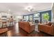 Open-concept living room showcasing a fireplace, TV, and a kitchen with granite countertops at 6441 Oakhurst Pl, Fairburn, GA 30213