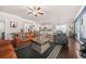 Bright living room featuring an open concept layout with hardwood floors, a modern kitchen, and cozy furniture at 6441 Oakhurst Pl, Fairburn, GA 30213