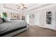 Spacious bedroom featuring a trey ceiling, carpet floors, and modern decor at 6441 Oakhurst Pl, Fairburn, GA 30213