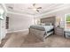 Spacious carpeted bedroom features a trey ceiling, a king bed, and natural light from the window at 6441 Oakhurst Pl, Fairburn, GA 30213