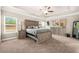 Spacious bedroom with a trey ceiling, large windows, and a full suite of furniture at 6441 Oakhurst Pl, Fairburn, GA 30213