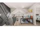 Upstairs landing area featuring a workspace with a statement wall and a view to a cozy bedroom at 6441 Oakhurst Pl, Fairburn, GA 30213