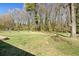 Large grassy backyard with mature trees, providing ample privacy at 8212 Englewood Trl, Riverdale, GA 30274