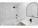 A modern bathroom with bathtub, toilet, sink, and sleek black fixtures at 8212 Englewood Trl, Riverdale, GA 30274