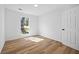 Neutral bedroom featuring wood floors and natural light at 8212 Englewood Trl, Riverdale, GA 30274