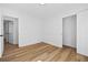 A bedroom with two doors and white walls and light colored wood floors at 8212 Englewood Trl, Riverdale, GA 30274