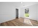 A clean, bright bedroom with a large window and light-colored wood floors at 8212 Englewood Trl, Riverdale, GA 30274