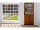 Bright entryway featuring a wood door, natural light from the window, and light-colored flooring at 8212 Englewood Trl, Riverdale, GA 30274