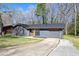 Charming home with blue siding, updated windows, and a concrete driveway at 8212 Englewood Trl, Riverdale, GA 30274