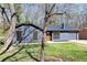Attractive one-story home featuring gray siding, a well-kept lawn, and complemented by mature trees at 8212 Englewood Trl, Riverdale, GA 30274