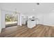 Bright kitchen features white cabinets, marble backsplash, stainless steel appliances, and wood floors at 8212 Englewood Trl, Riverdale, GA 30274