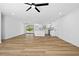 Bright, open-concept living space with a modern kitchen featuring white cabinets and stainless steel appliances at 8212 Englewood Trl, Riverdale, GA 30274