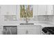 This kitchen has stainless steel appliances, white cabinets, and luxurious quartz countertops at 8212 Englewood Trl, Riverdale, GA 30274