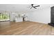 Open-concept living space with a kitchen featuring white cabinets and stainless steel appliances at 8212 Englewood Trl, Riverdale, GA 30274