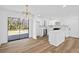 Bright kitchen features white cabinets, marble backsplash, stainless steel appliances, and wood floors at 8212 Englewood Trl, Riverdale, GA 30274