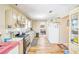 Well-lit kitchen boasts modern appliances, tile backsplash, lots of counter space, and an open view to the dining area at 1138 Alford Rd, Lithonia, GA 30058