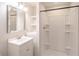 Bright bathroom features a modern vanity, framed mirror, and a tiled shower with glass doors at 2090 Sand Wedge Nw Cir, Kennesaw, GA 30144